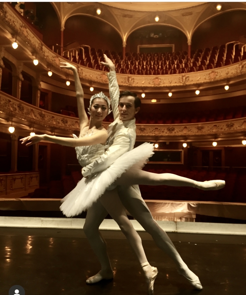 A triumphant figure raising a glowing orb