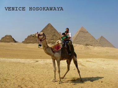 camel riding in front of pyramid