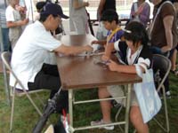 天文協会のブース 日食めがね作製の様子