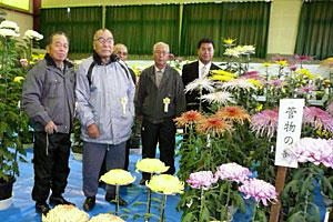 丹精込めて育てた菊を前に記念撮影