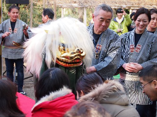 子供の頭を咬むそぶりを見せる獅子