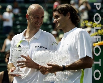 Ivan Ljubicic, left, of Croatia, and Roger Federer, of Switzerland, hold their trophies after the men's singles championship of the Nasdaq-100 Open tennis tournament Sunday, April 2, 2006